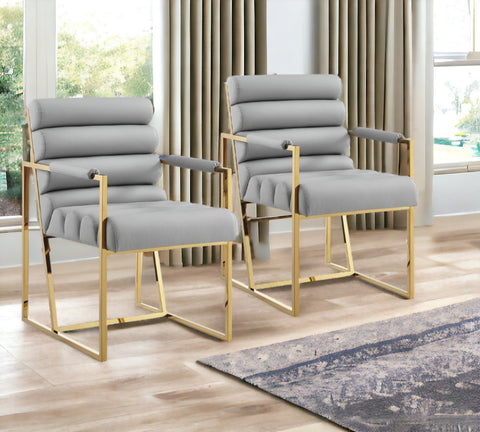 Set of Two Tufted Gray And Gold Upholstered Faux Leather Dining Arm Chairs